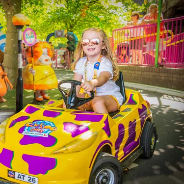 Cuckoocars Girl driving yellow and purple car